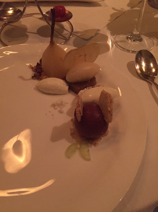 Dessert dish including Concord grape sorbet, some sort of cookie with cream cheese ice cream on top, a jellied fig thing, and a poached pear.